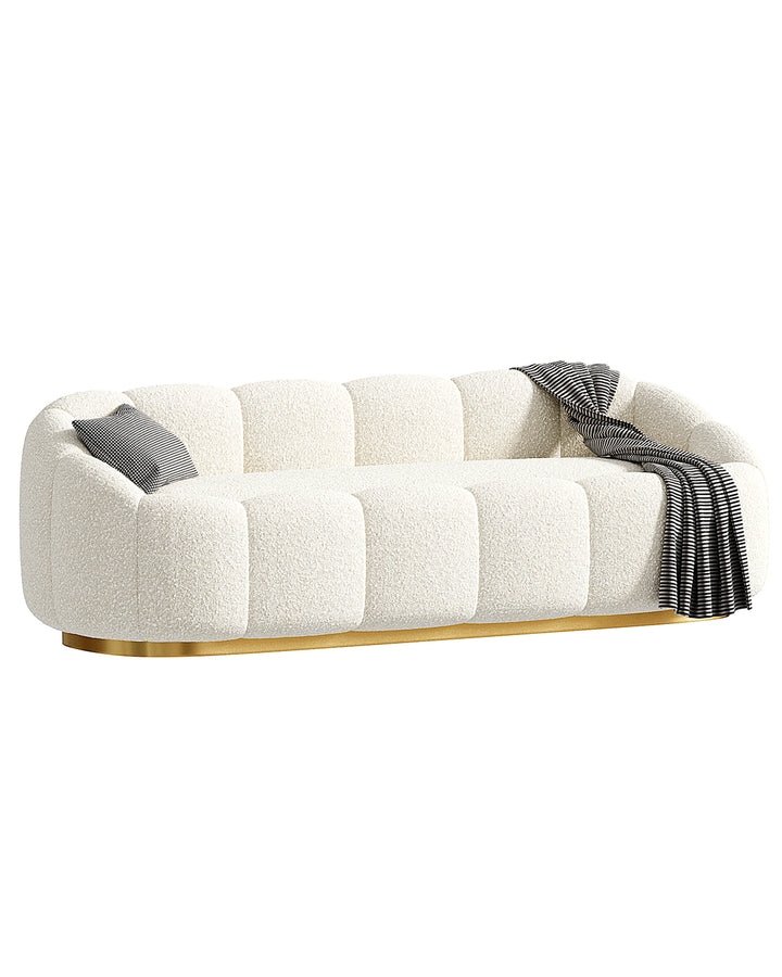 Luxury modern sofa with tufted design, soft cream fabric, and golden base – INSIDE HOME.