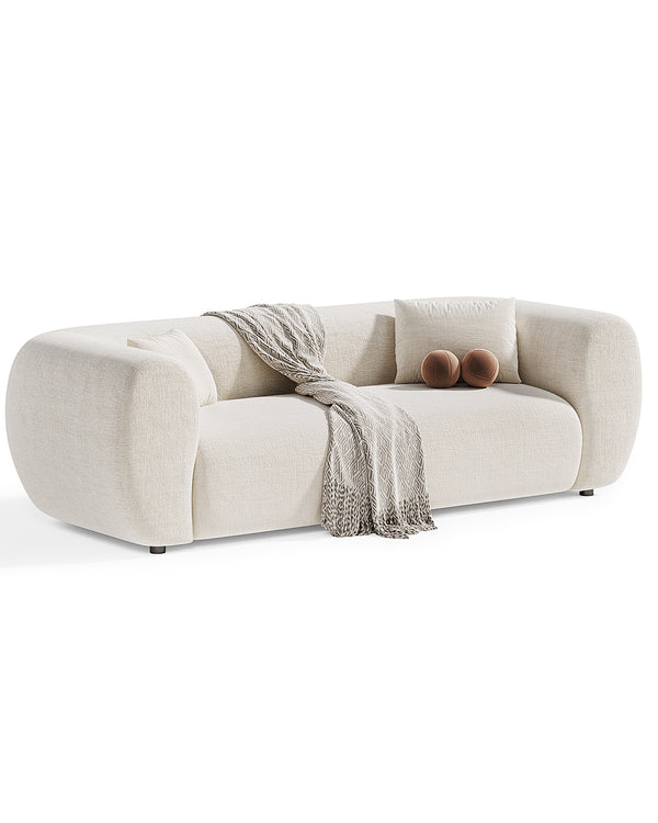 Elegant modern sofa with soft rounded edges, upholstered in premium light fabric with accent pillows – INSIDE HOME.