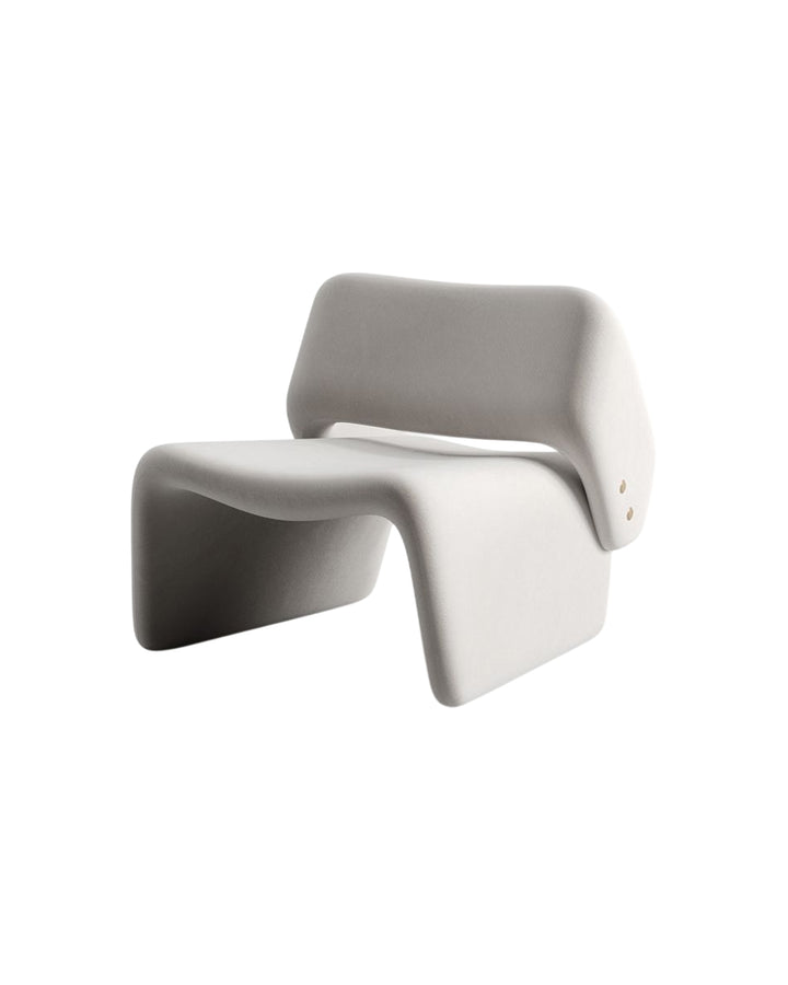 Side angle of Aeris Armchair showcasing its artistic curved silhouette