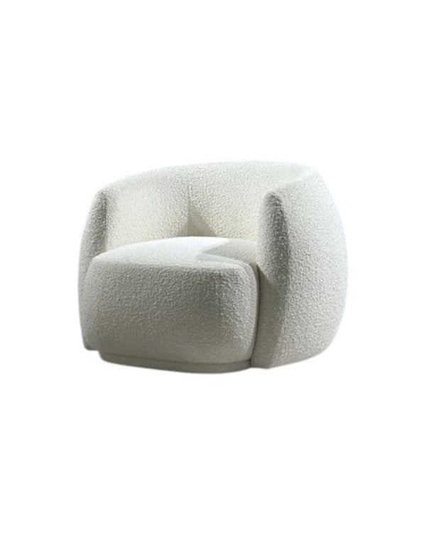 Front view of Marella Armchair with rounded silhouette and plush cushioning. Side view of Marella Armchair showing its smooth curves and contemporary design.