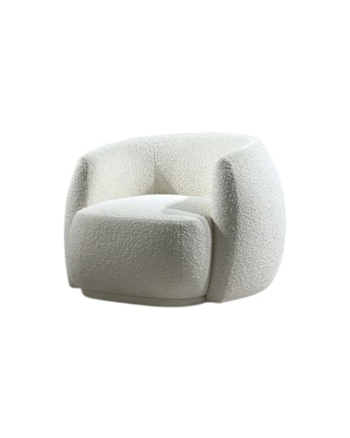 Front view of Marella Armchair with rounded silhouette and plush cushioning. Side view of Marella Armchair showing its smooth curves and contemporary design.