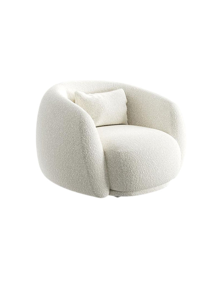 Side angle of Aveline Armchair showing smooth curves and contemporary upholstered design.