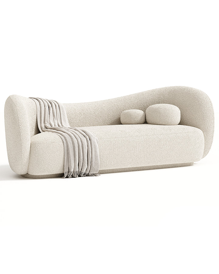 Modern SAVINA Sofa with soft curved design and plush cushions, upholstered in premium fabric, ideal for luxury living room interiors.