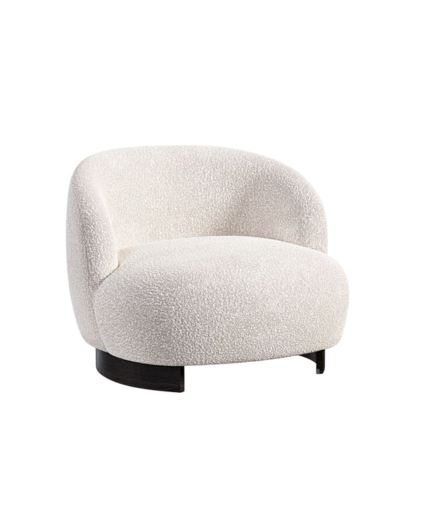 Side angle of Marcel Armchair highlighting curved backrest and plush seating.