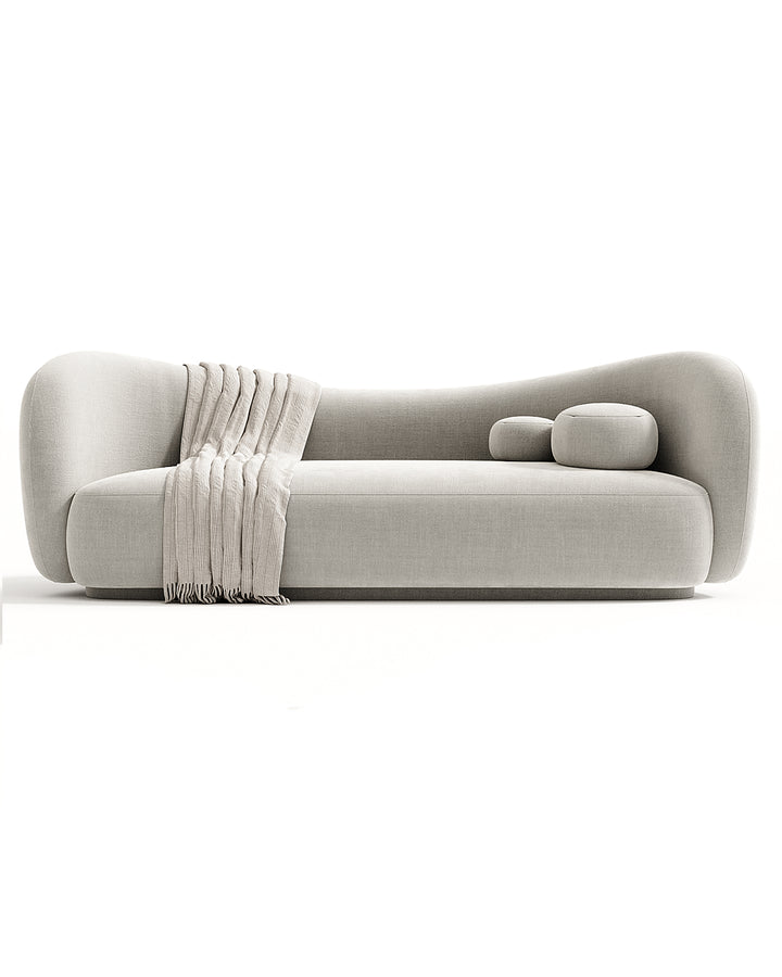 Modern SAVINA Sofa with soft curved design and plush cushions, upholstered in premium fabric, ideal for luxury living room interiors.