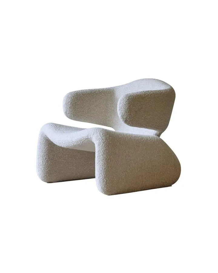 Side angle of Sculptura Armchair showcasing its artistic silhouette