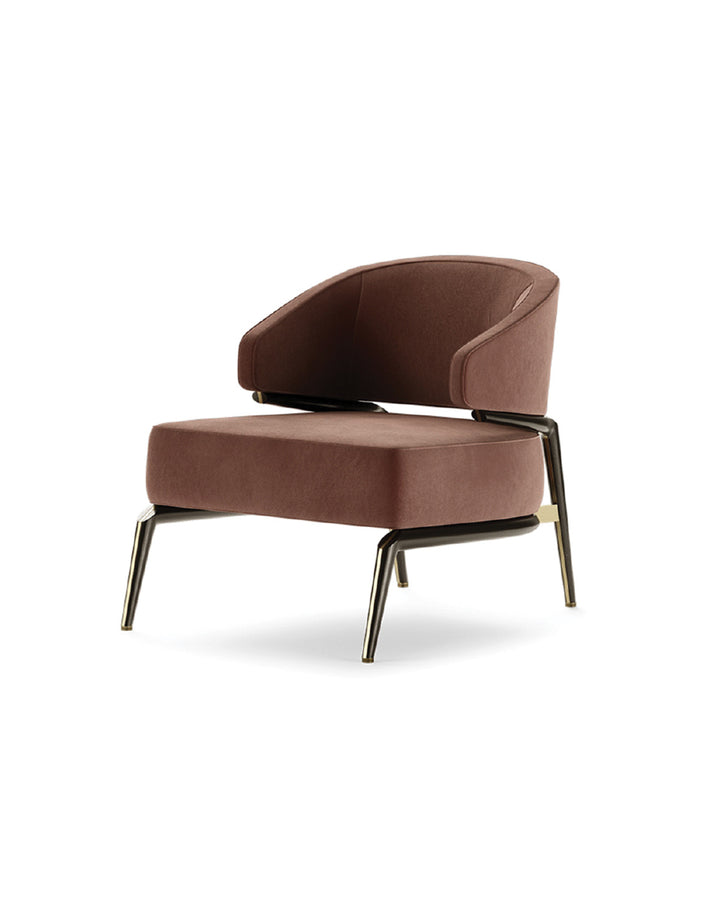Rivano Armchair side view – luxury modern velvet armchair with brushed gold legs and a sleek silhouette, by INSIDE HOME.