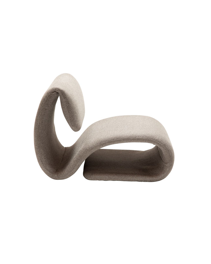 Side view of Flow Armchair showcasing its fluid wave-like form and minimalist design.