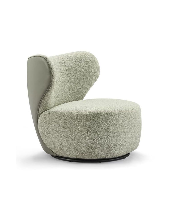 Lunare armchair side view highlighting sculptural backrest and modern contemporary design by INSIDE HOME.