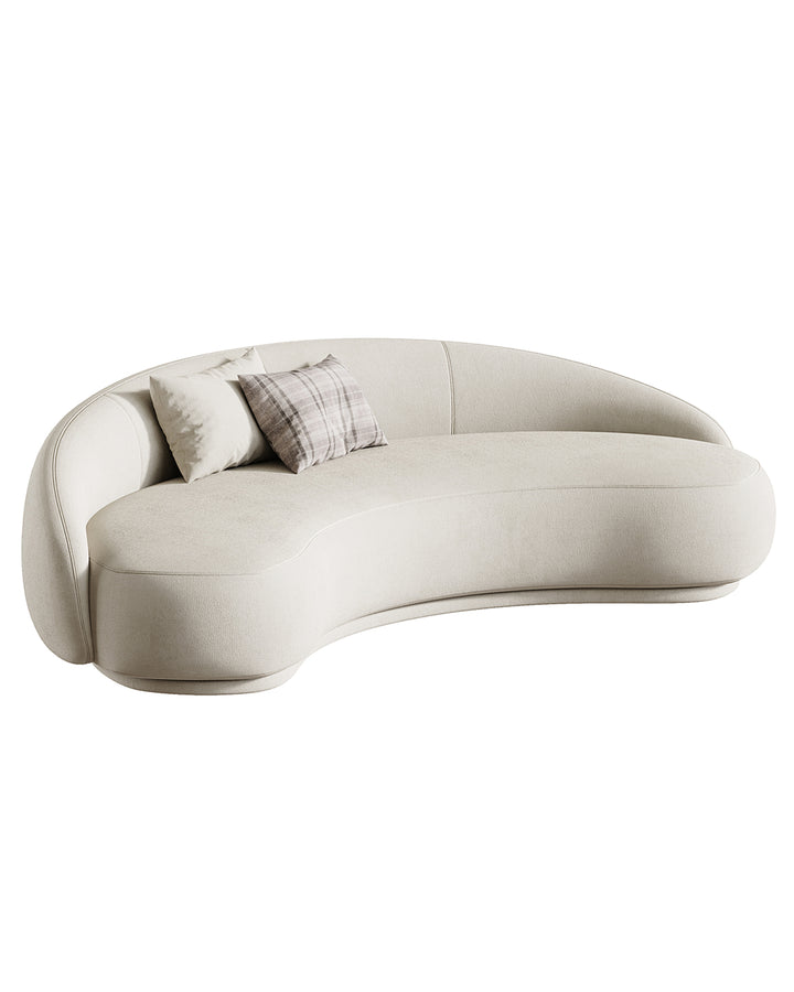 Modern curved sofa ARCANA in light fabric with soft cushions and sculptural design.